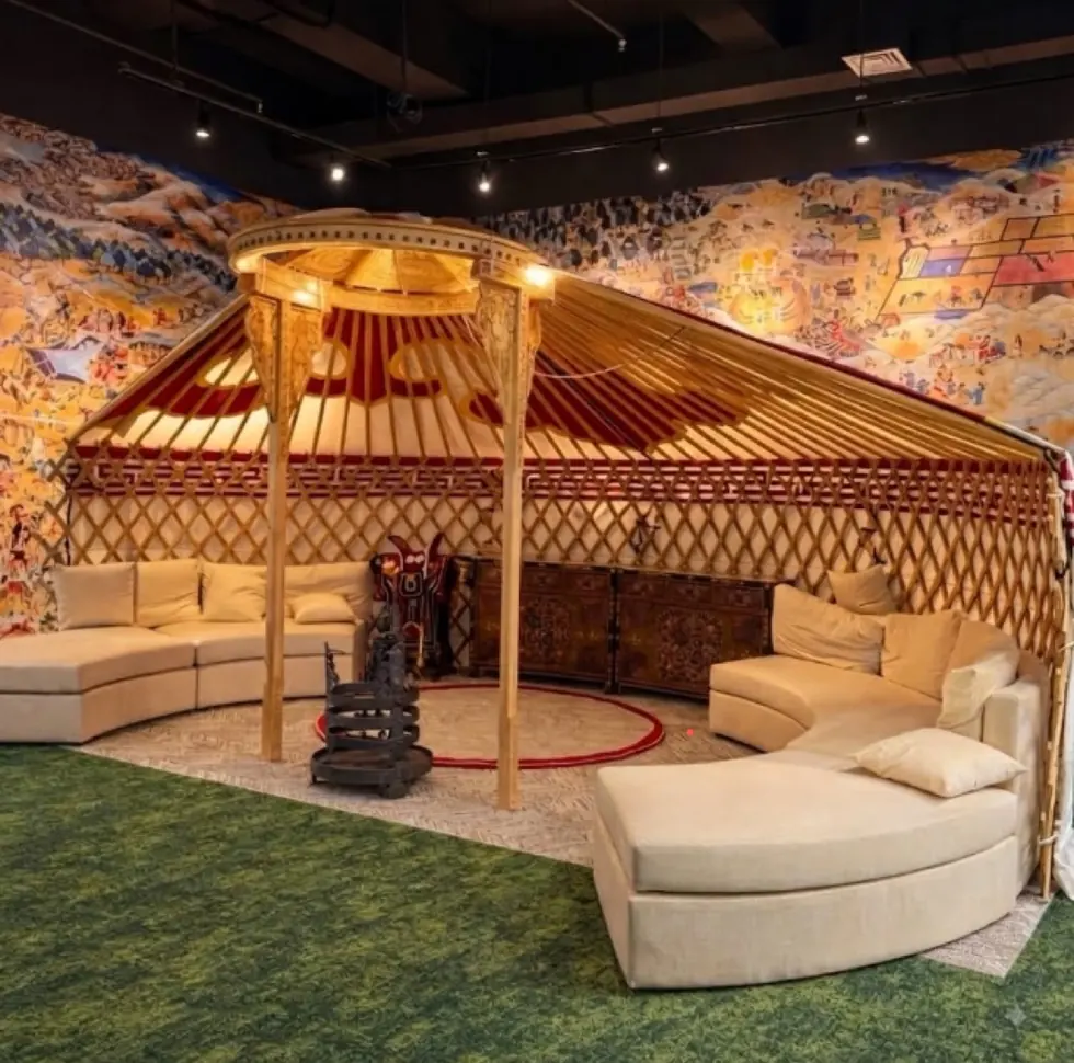 A full Mongolian ger built inside the DDAM office, surrounded by a painted mural of Mongolian history