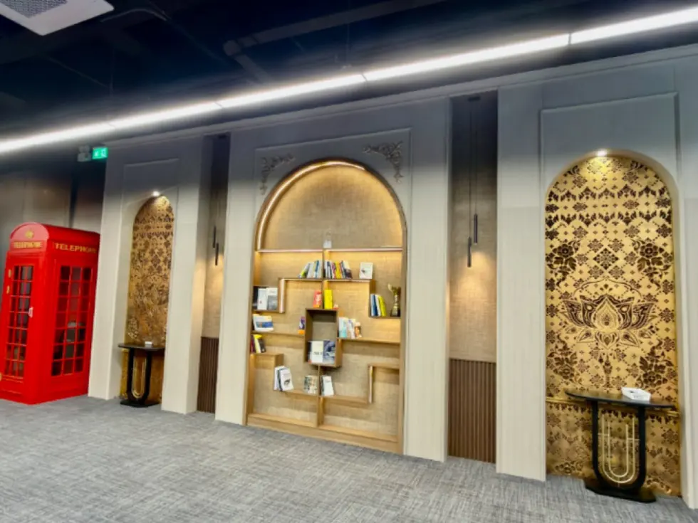 Knowledge hub with arched library alcoves, ornamental panels and a red British telephone box
